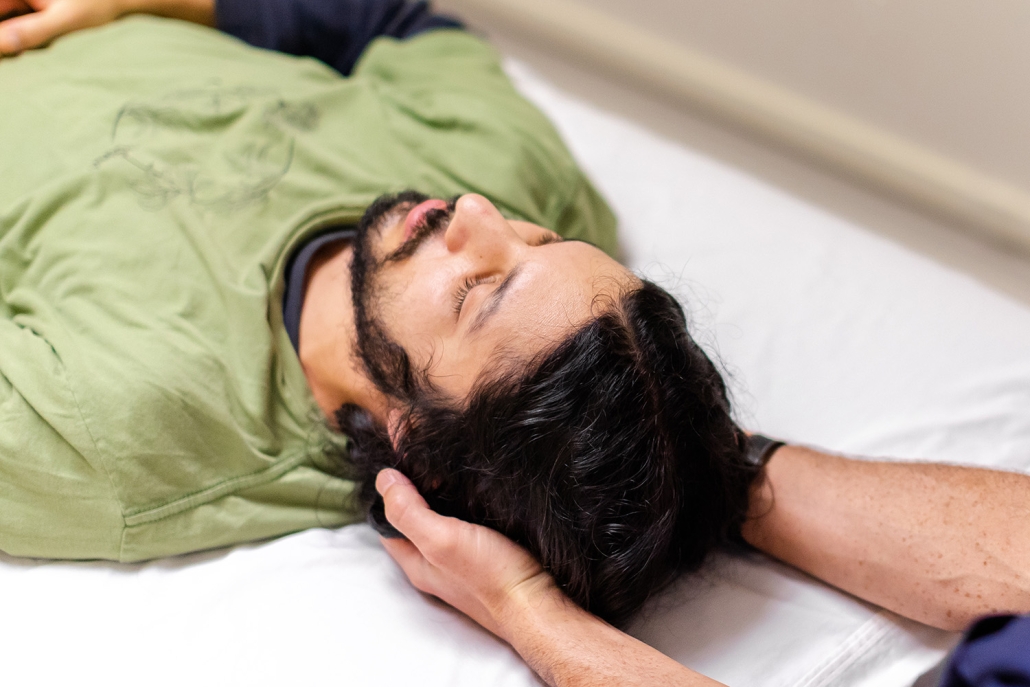 Patient lying on bed receiving treatment